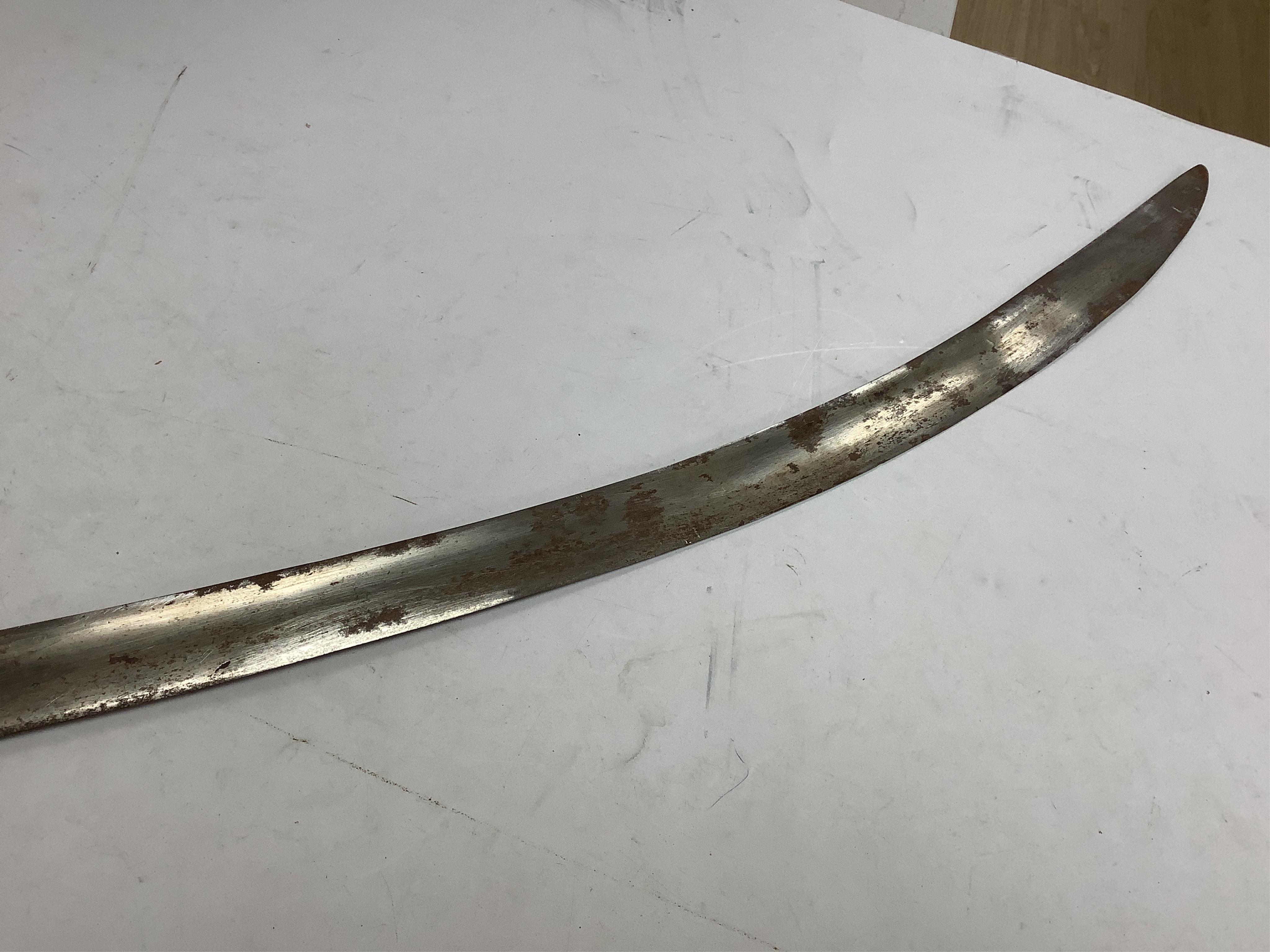 An Indian Tulwar sword, in scabbard and two small kukri, largest 93cm long.